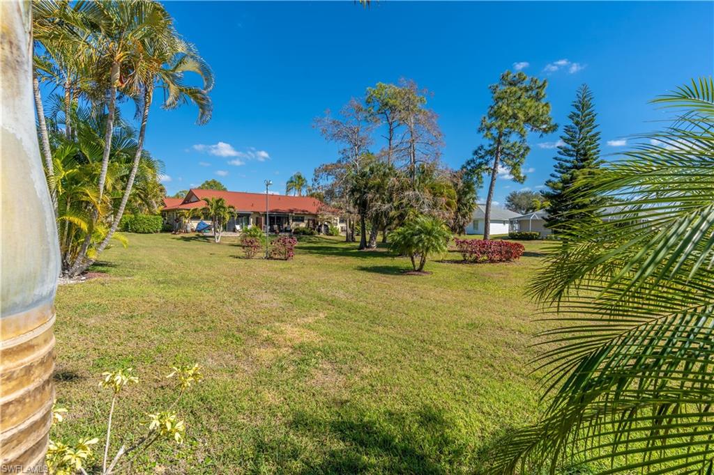 2048 Pine Isle Lane, Unit 2048 Naples, FL 34112 - Photo 36 of 50 a view of a yard with an outdoor space