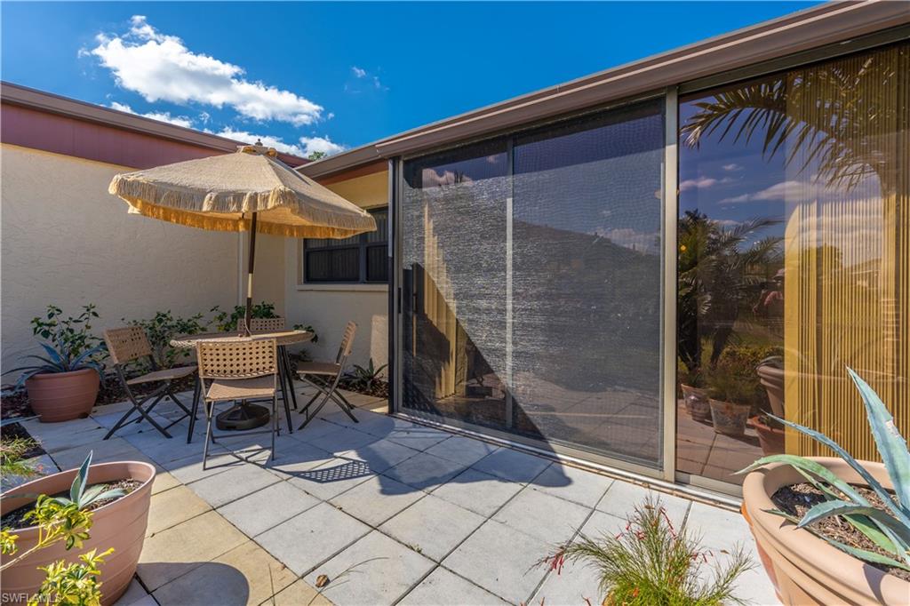 2048 Pine Isle Lane, Unit 2048 Naples, FL 34112 - Photo 38 of 50 a outdoor space with lots of tables and chairs
