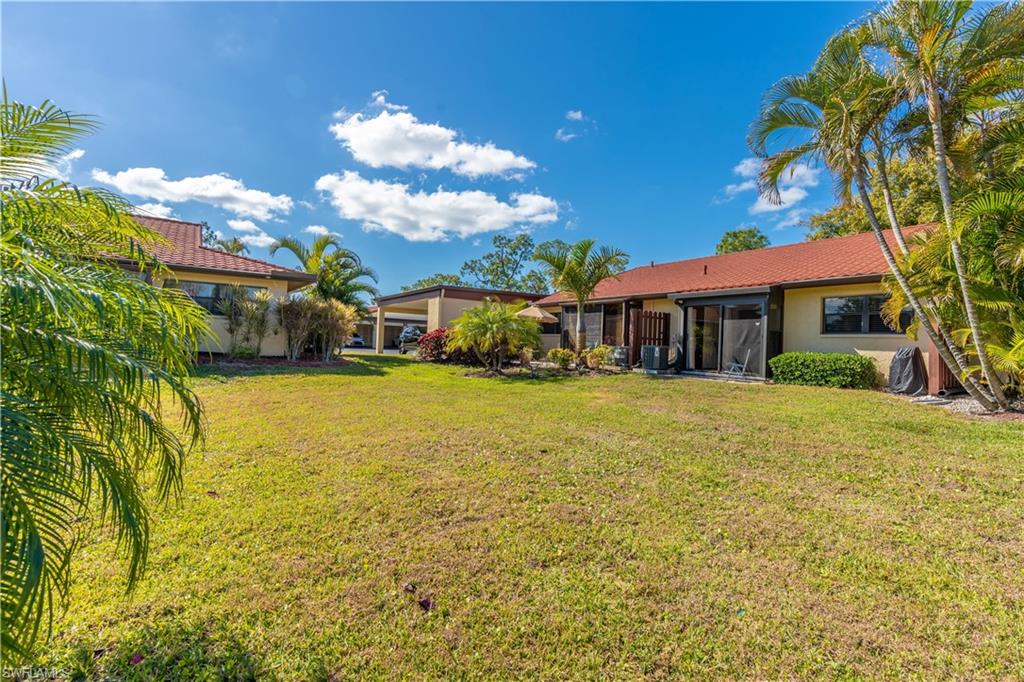 2048 Pine Isle Lane, Unit 2048 Naples, FL 34112 - Photo 39 of 50 a view of a house with a yard