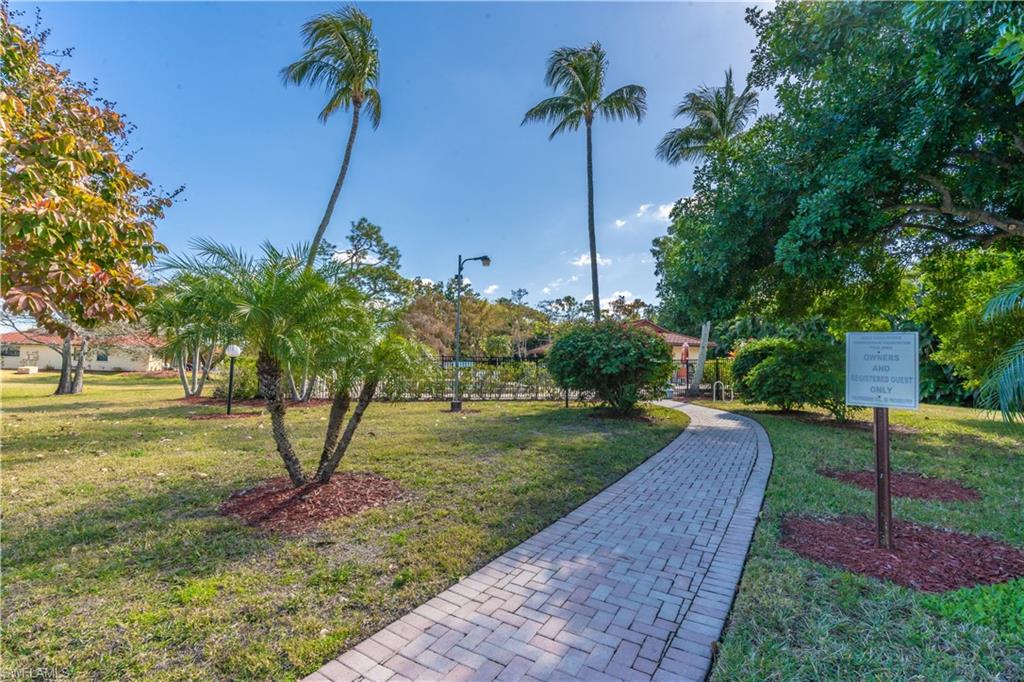 2048 Pine Isle Lane, Unit 2048 Naples, FL 34112 - Photo 40 of 50 a view of a garden with a tree