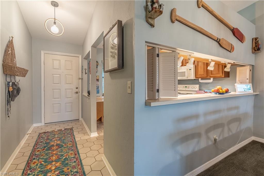 2048 Pine Isle Lane, Unit 2048 Naples, FL 34112 - Photo 4 of 50 a view of an entryway with wooden floor