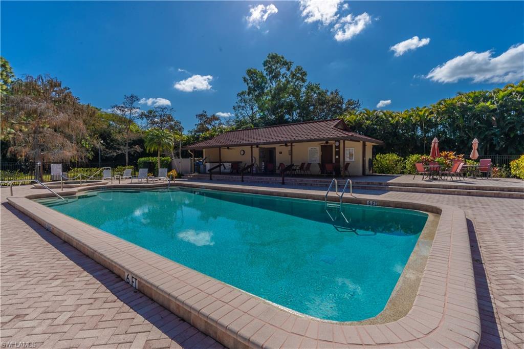 2048 Pine Isle Lane, Unit 2048 Naples, FL 34112 - Photo 43 of 50 a view of a swimming pool with a garden