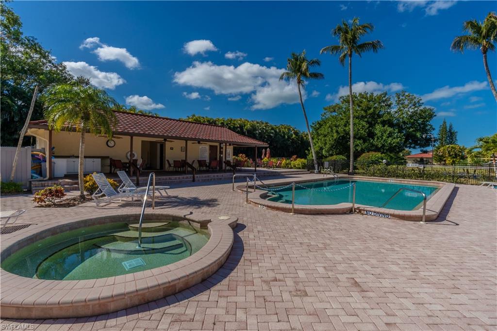 2048 Pine Isle Lane, Unit 2048 Naples, FL 34112 - Photo 44 of 50 a view of a swimming pool with sitting area