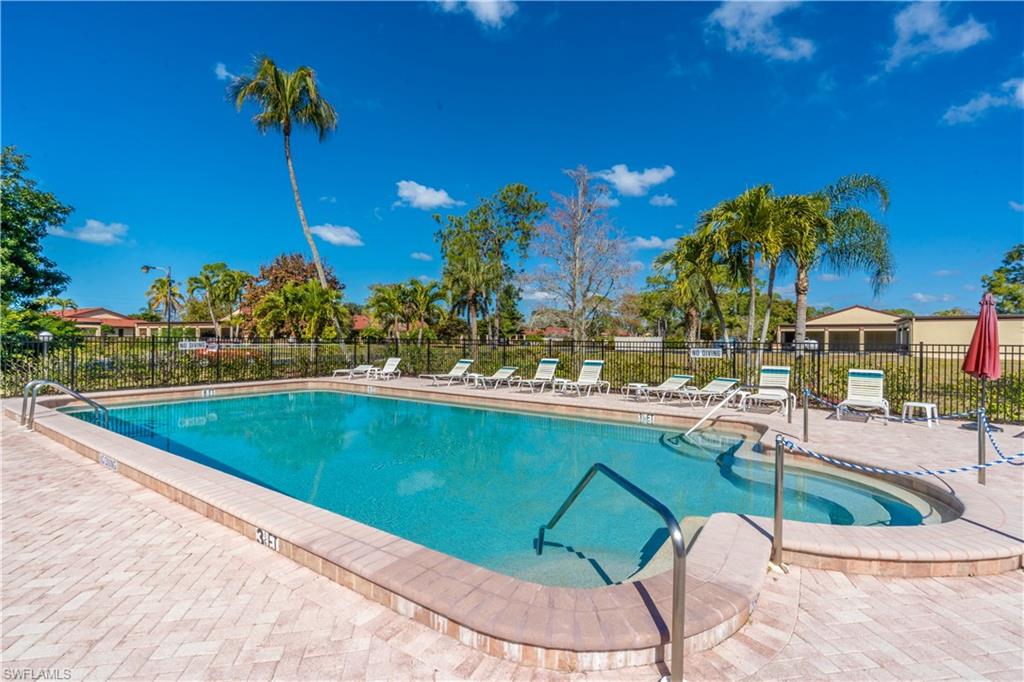 2048 Pine Isle Lane, Unit 2048 Naples, FL 34112 - Photo 48 of 50 a view of swimming pool with outdoor seating and plants
