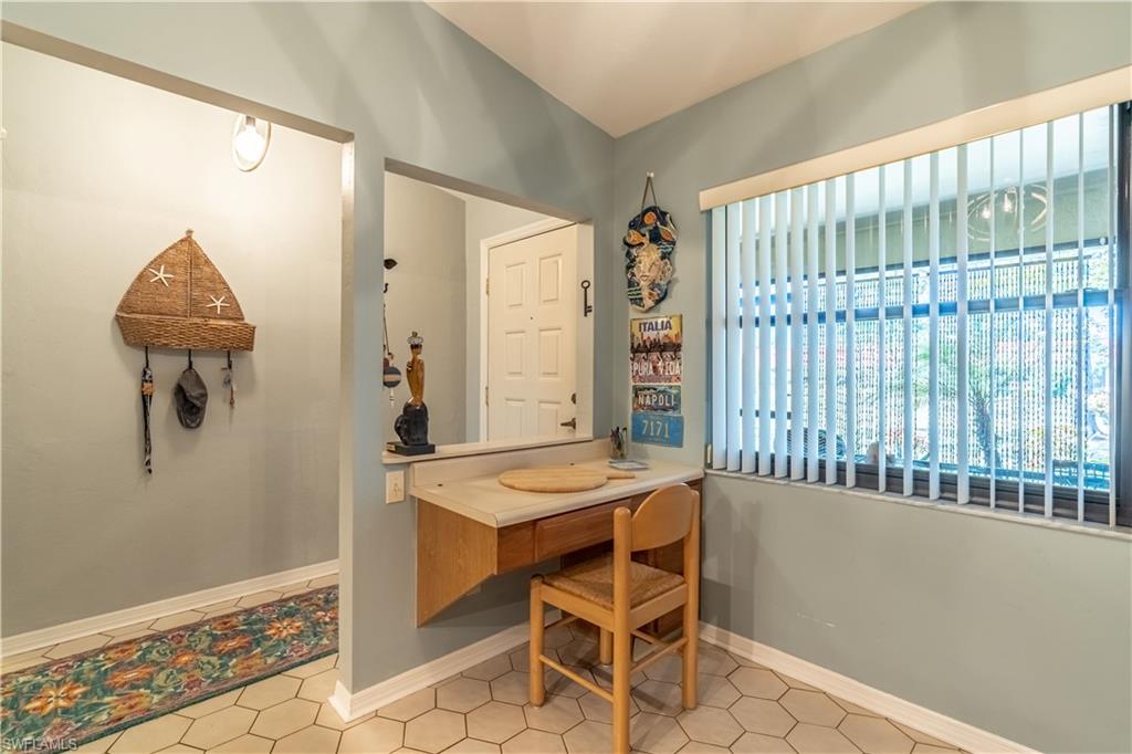 2048 Pine Isle Lane, Unit 2048 Naples, FL 34112 - Photo 5 of 50 a dining room with furniture and a window