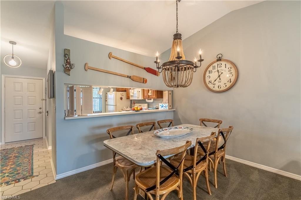 2048 Pine Isle Lane, Unit 2048 Naples, FL 34112 - Photo 7 of 50 a view of a table and chairs in a room