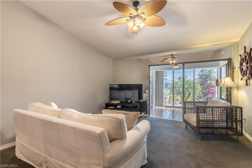 2048 Pine Isle Lane, Unit 2048 Naples, FL 34112 - Photo 9 of 50 a living room with furniture and a large window