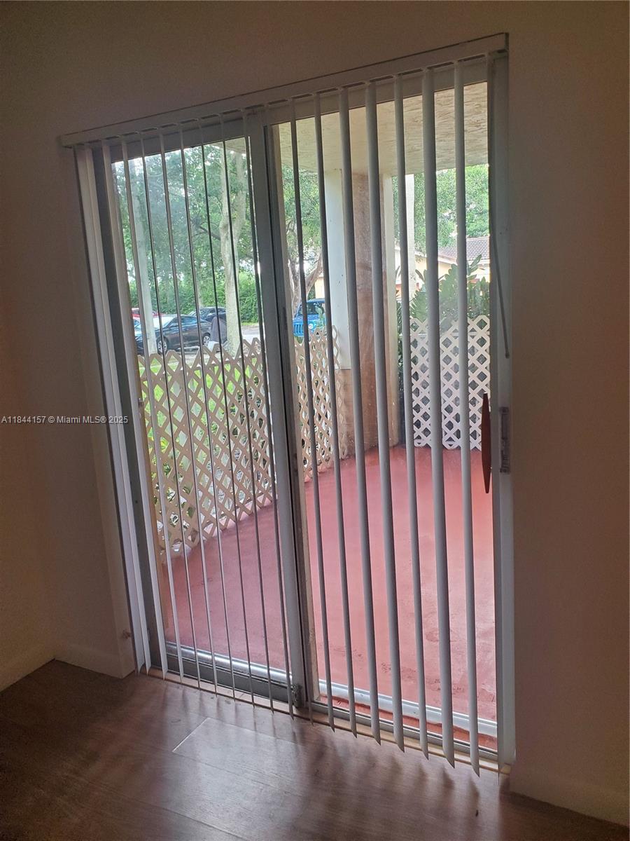3874 Lyons Road, Unit 1126 Coconut Creek, FL 33073 - Photo 11 of 22 a view of a porch with wooden floor