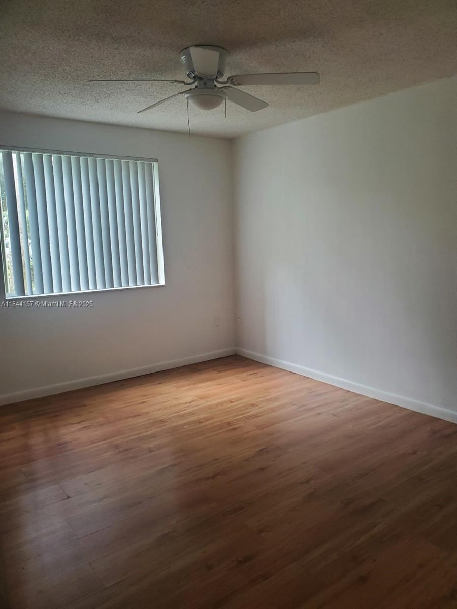 3874 Lyons Road, Unit 1126 Coconut Creek, FL 33073 - Photo 20 of 22 a view of an empty room with a window