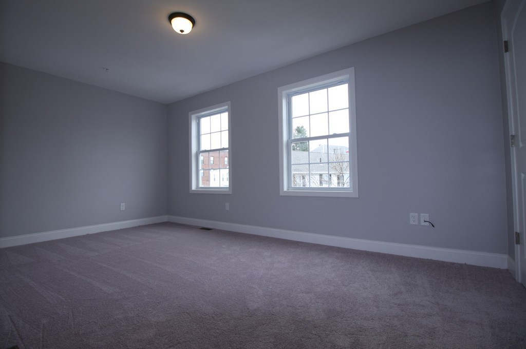 7 Butler Avenue, Unit B Lowell, MA 01852 - Photo 11 of 21 an empty room with windows