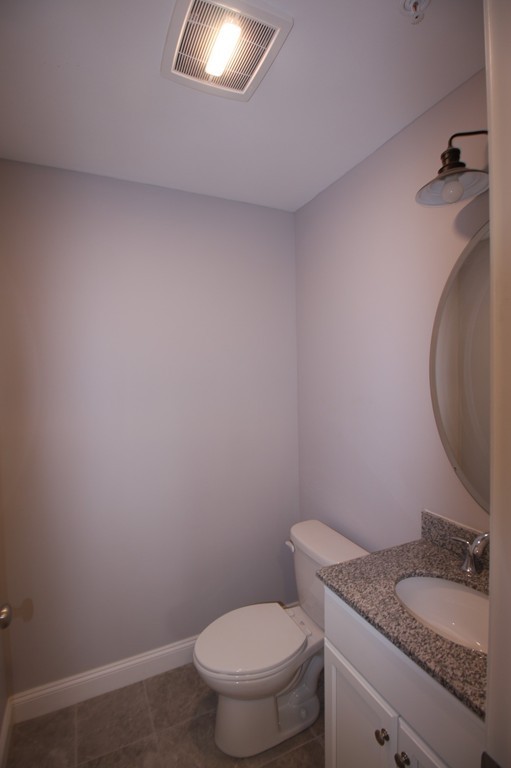 7 Butler Avenue, Unit B Lowell, MA 01852 - Photo 16 of 21 a bathroom with a granite countertop toilet and a sink