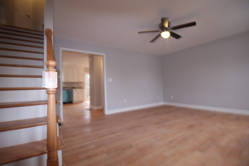 7 Butler Avenue, Unit B Lowell, MA 01852 - Photo 7 of 21 a view of empty room with wooden floor and fan