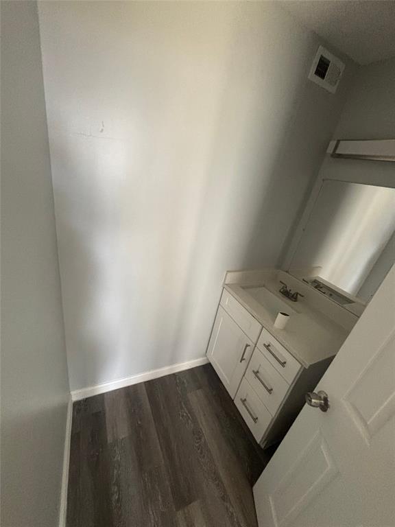 301 Rolston Road, Unit 317103 Irving, TX 75060 - Photo 2 of 9 Vanity area featuring a built-in white cabinet with storage drawers, a white countertop, and an integrated sink