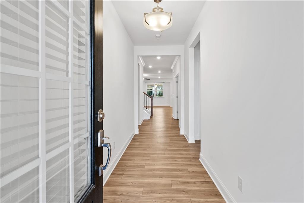 1204 Tahoe Place Canton, GA 30114 - Photo 12 of 73 a view of a hallway with wooden floor and staircase