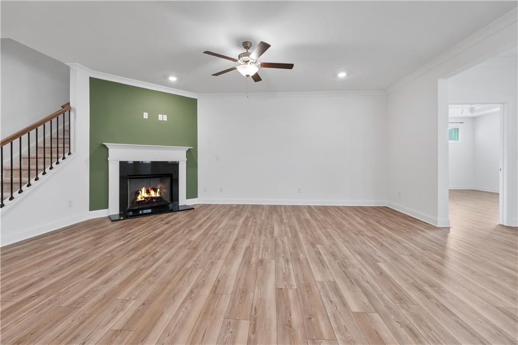 1204 Tahoe Place Canton, GA 30114 - Photo 13 of 73 a view of an empty room with wooden floor fireplace and a window