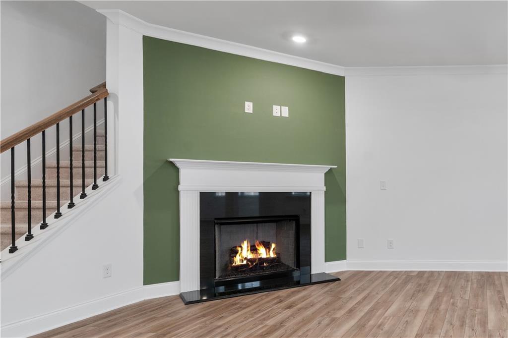 1204 Tahoe Place Canton, GA 30114 - Photo 15 of 73 a view of an empty room with wooden floor and a fireplace