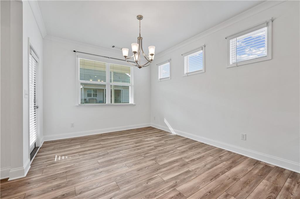 1204 Tahoe Place Canton, GA 30114 - Photo 22 of 73 wooden floor in an empty room with a window