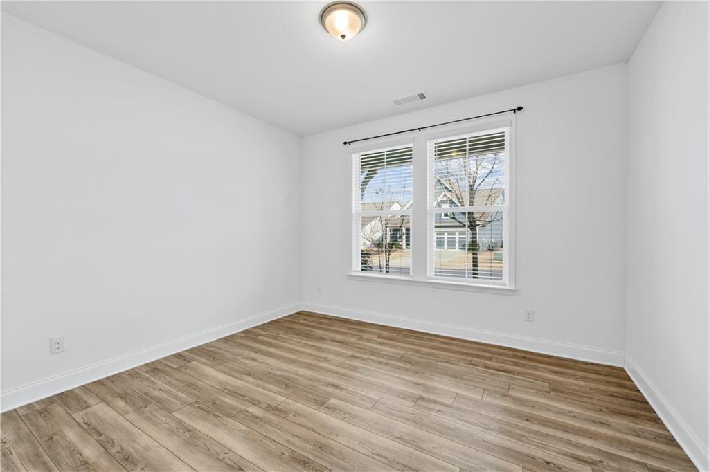 1204 Tahoe Place Canton, GA 30114 - Photo 25 of 73 an empty room with wooden floor and windows