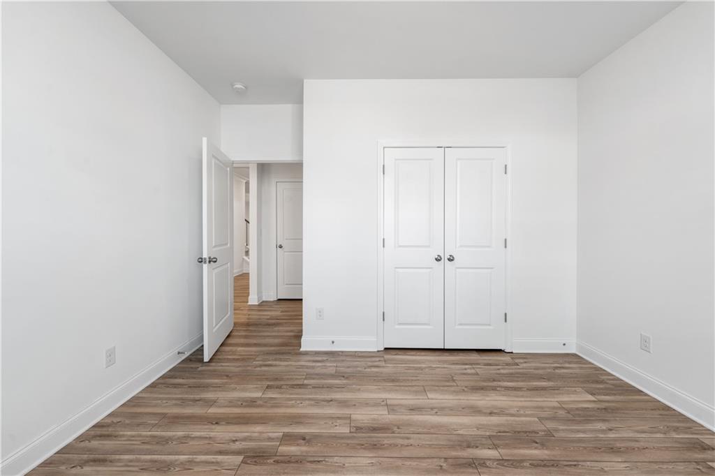 1204 Tahoe Place Canton, GA 30114 - Photo 26 of 73 a view of an empty room with wooden floor