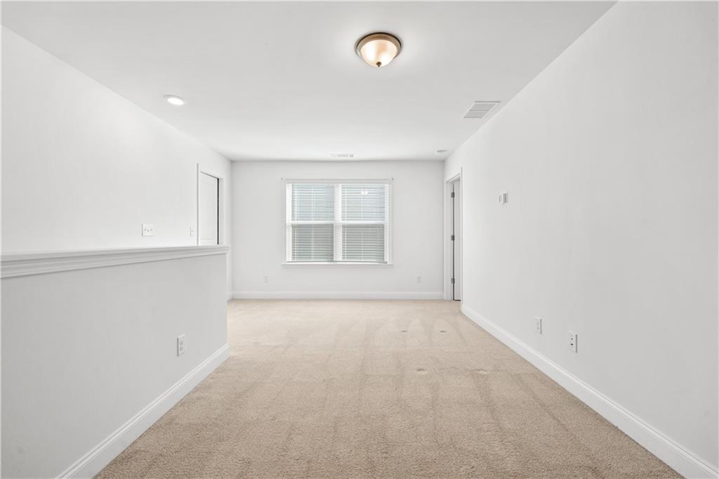 1204 Tahoe Place Canton, GA 30114 - Photo 39 of 73 an empty room with a empty space and windows