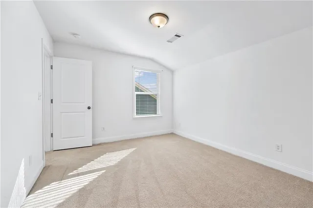 a large kitchen with cabinets wooden floor and stainless steel appliances