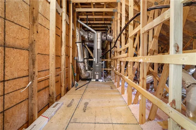 a living room with stainless steel appliances kitchen island granite countertop a dining table chairs stove a refrigerator and a dining table with wooden floor