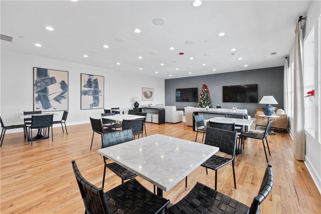 1204 Tahoe Place Canton, GA 30114 - Photo 60 of 73 a living room with stainless steel appliances kitchen island granite countertop a dining table chairs stove a refrigerator and a dining table with wooden floor