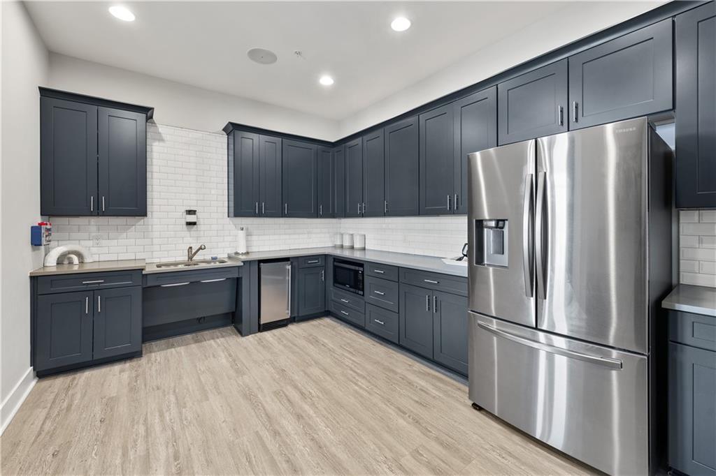 1204 Tahoe Place Canton, GA 30114 - Photo 65 of 73 a kitchen with stainless steel appliances granite countertop a refrigerator a sink dishwasher a stove with wooden floors and cabinets