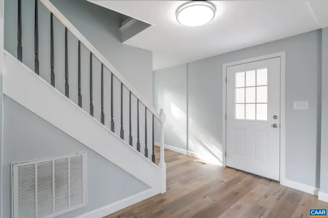 wooden floor with windows and stairs