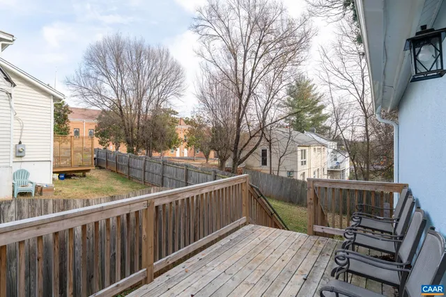 a view of a roof deck with wooden fence and floor