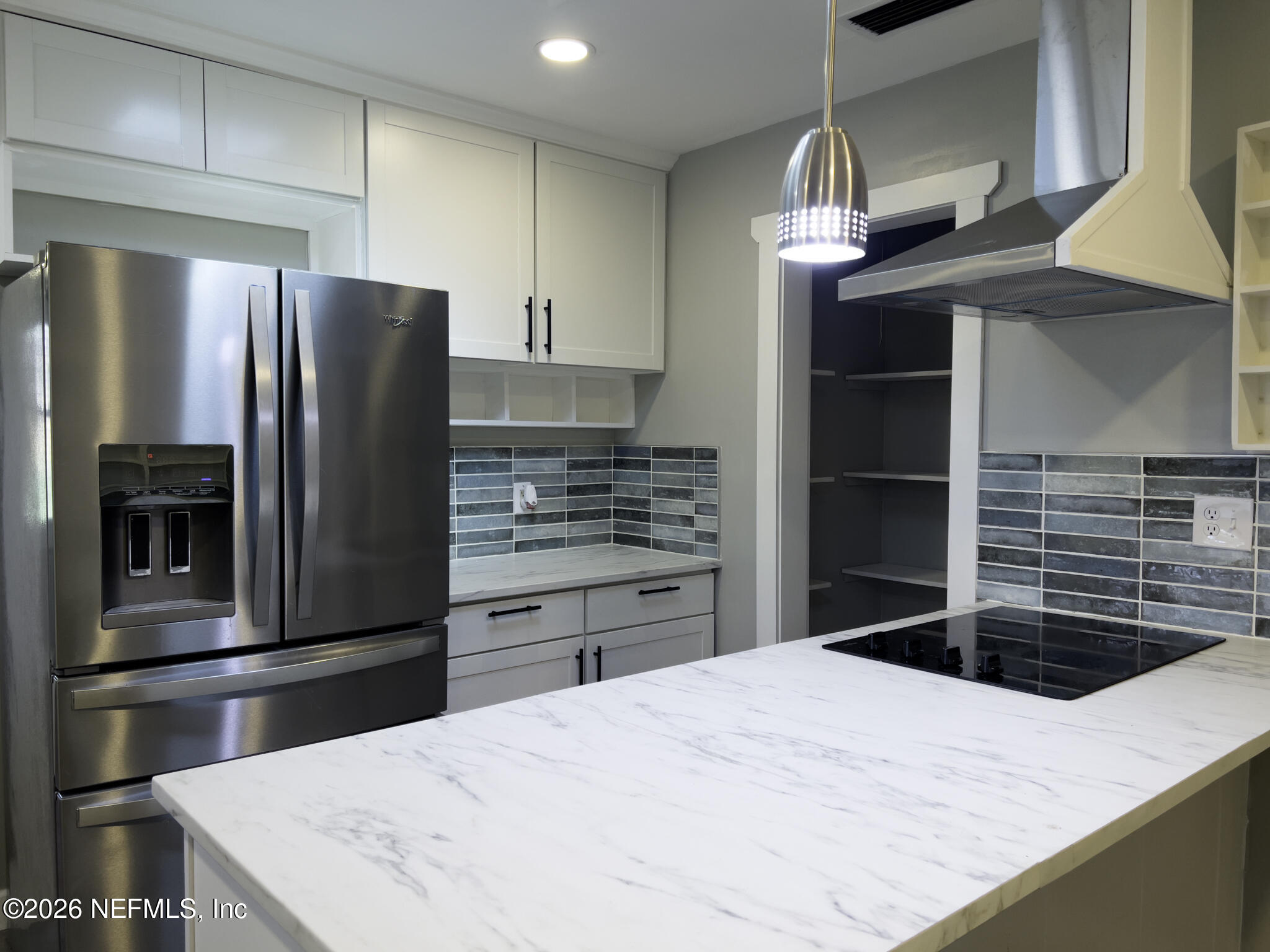 2085 Mills Road Jacksonville, FL 32216 - Photo 3 of 13 a kitchen with kitchen island a sink a counter and stainless steel appliances