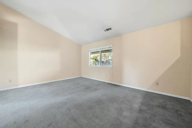 a view of an empty room with closet