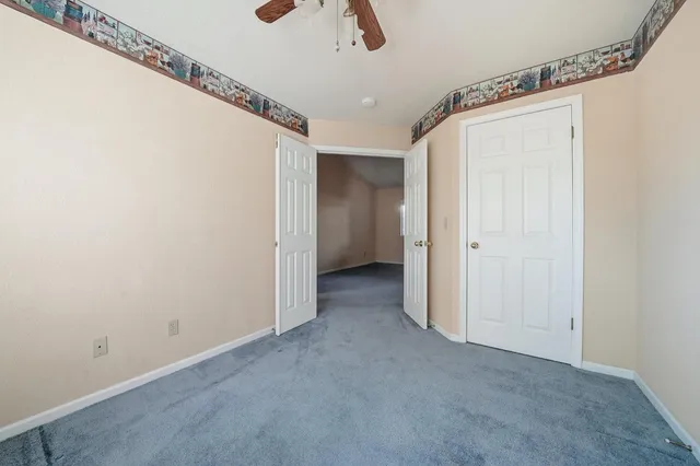 a view of room with window and ceiling fan