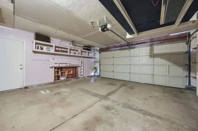 an empty room with a view of a kitchen