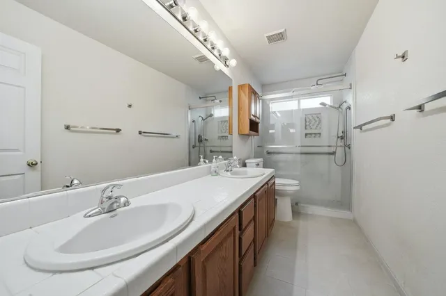 a spacious bathroom with a sink and a mirror