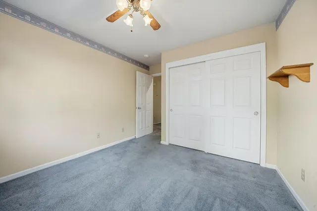 a bathroom with a granite countertop sink mirror and a bath tub