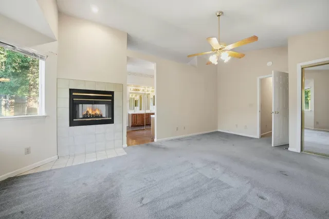 a view of a house with a yard and large tree