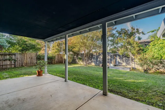 an aerial view of a house with a yard and lake view