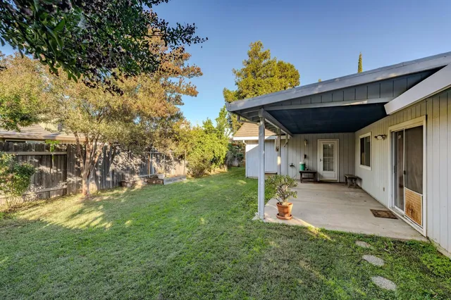 an aerial view of a building with an outdoor space and seating
