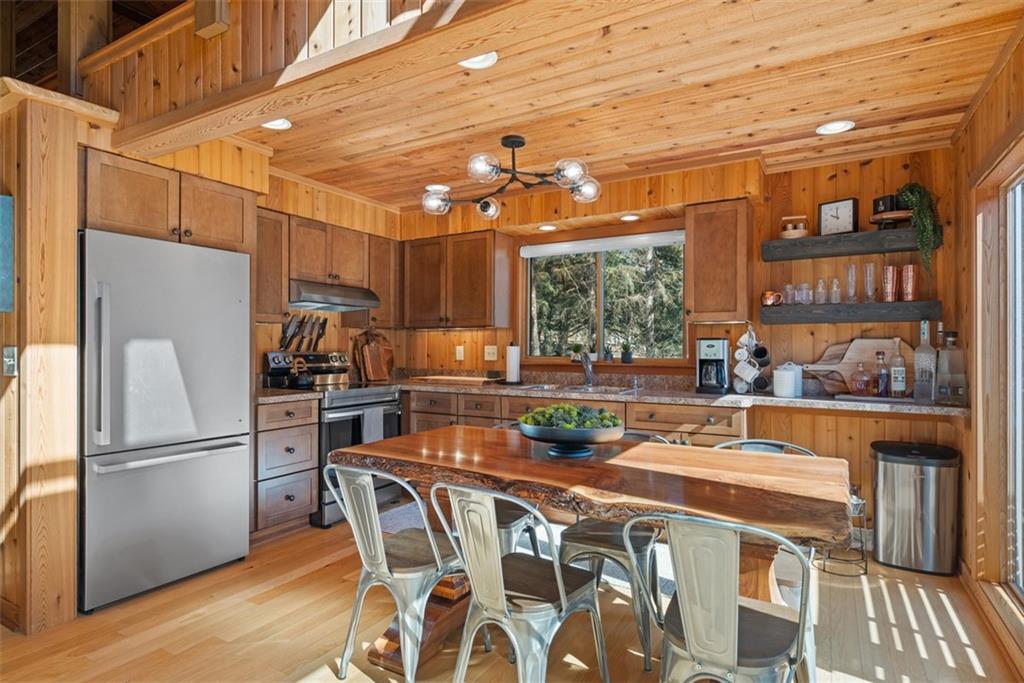192 Mountain Laurel Road Emlenton, PA 16373 - Photo 13 of 50 Meal time prep will be a breeze in this spacious kitchen. (The kitchen table and chairs are not included with the sale.) Newer electric range and kitchen refrigerator!