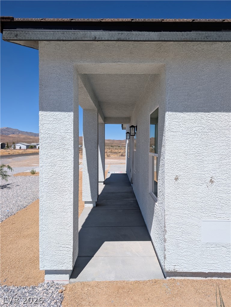 4670 Medicine Man Road Pahrump, NV 89048 - Photo 5 of 36 A sheltered entry with modern outdoor lighting welcomes visitors to this desert residence.