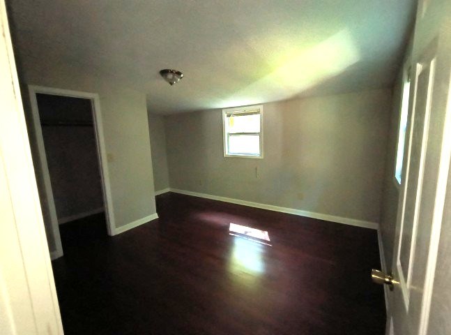 911 Tipton Road Blue Ridge, GA 30513 - Photo 11 of 20 an empty room with wooden floor and windows