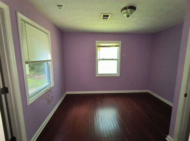 911 Tipton Road Blue Ridge, GA 30513 - Photo 12 of 20 an empty room with wooden floor and windows