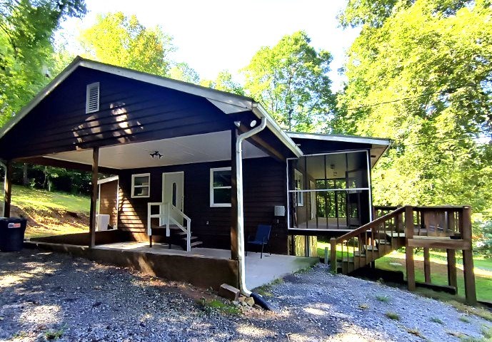 911 Tipton Road Blue Ridge, GA 30513 - Photo 4 of 20 a view of a house with a yard porch and furniture