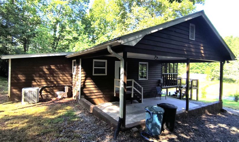 911 Tipton Road Blue Ridge, GA 30513 - Photo 5 of 20 a view of a patio with table and chairs under an umbrella