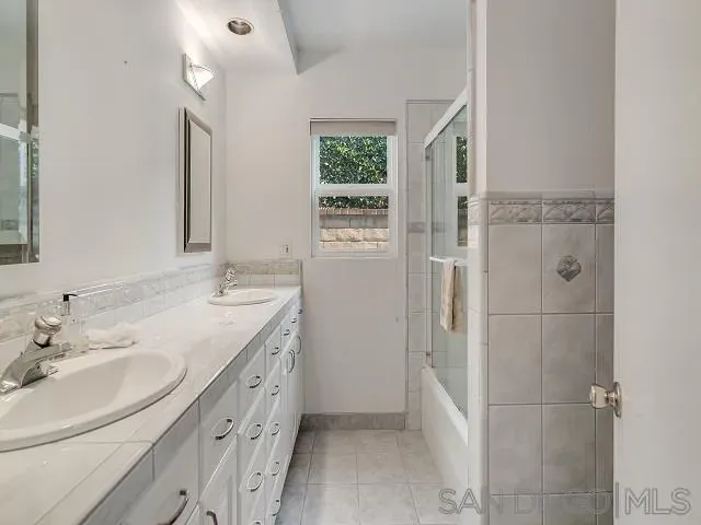 a bathroom with a double vanity sink a and a shower