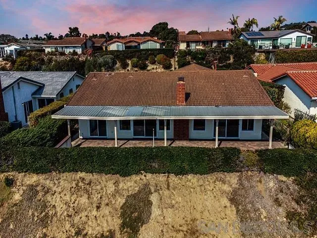 a aerial view of a house next to a yard
