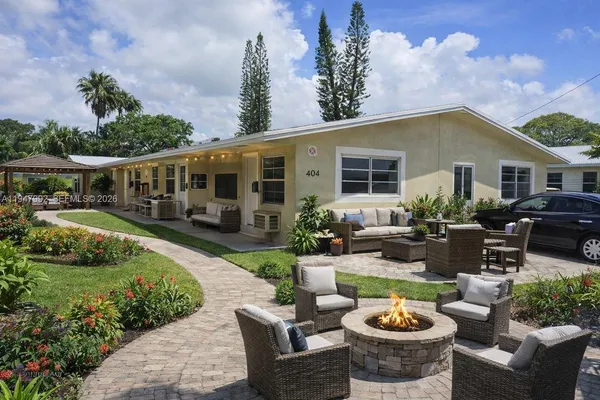 a view of a patio with couches chairs and a fire pit