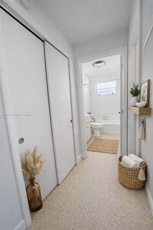 a bathroom with a tub shower and a sink