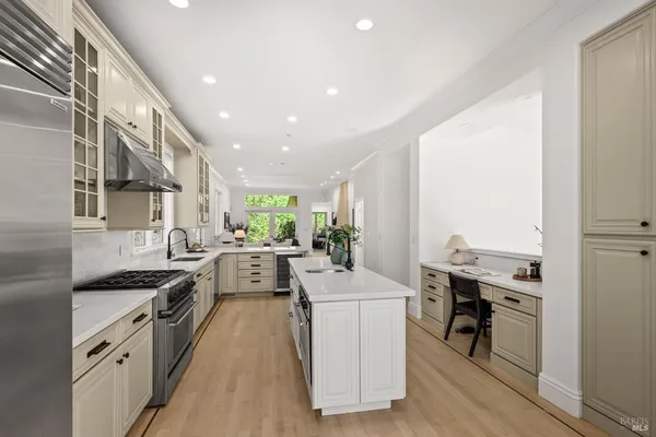 a kitchen with a sink a stove top oven and cabinets